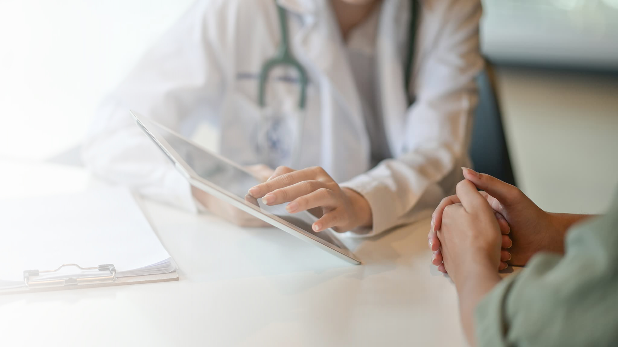 Doctor showing patient an iPad